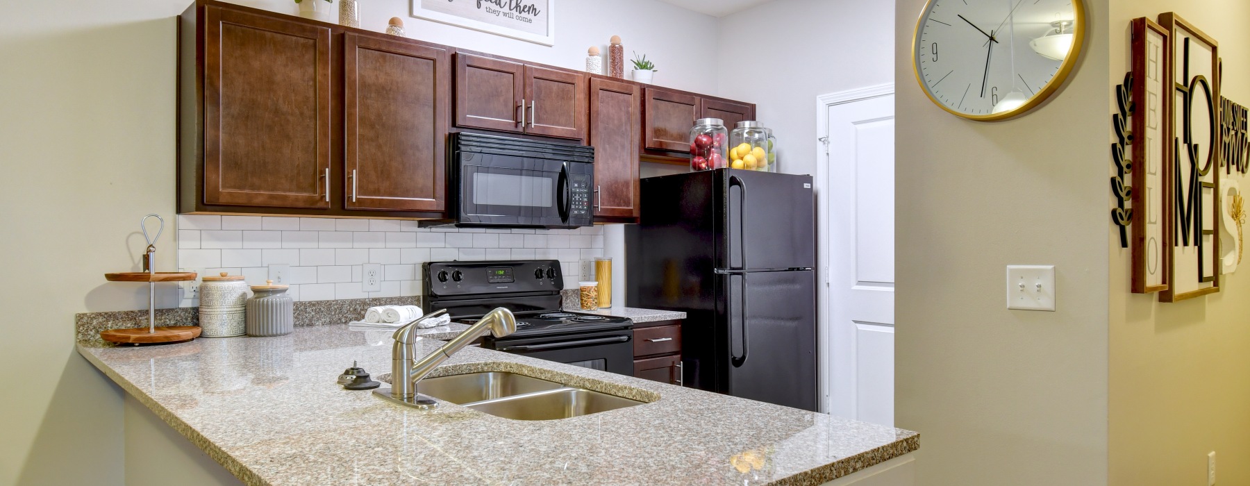 Kitchen with brown cabinets and black appliances