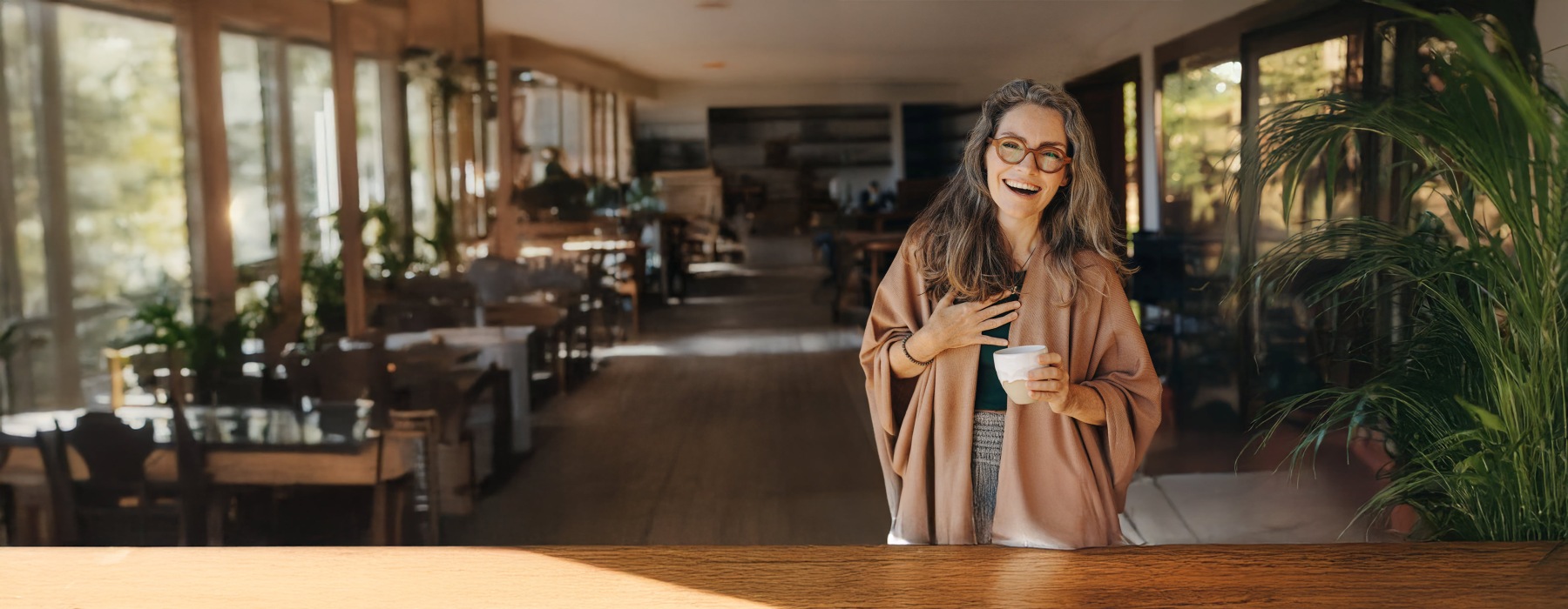 a woman in a shop holding coffee