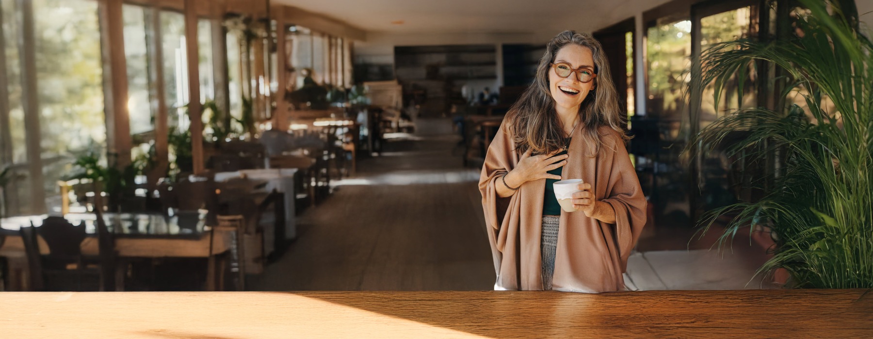 a woman in a shop holding coffee