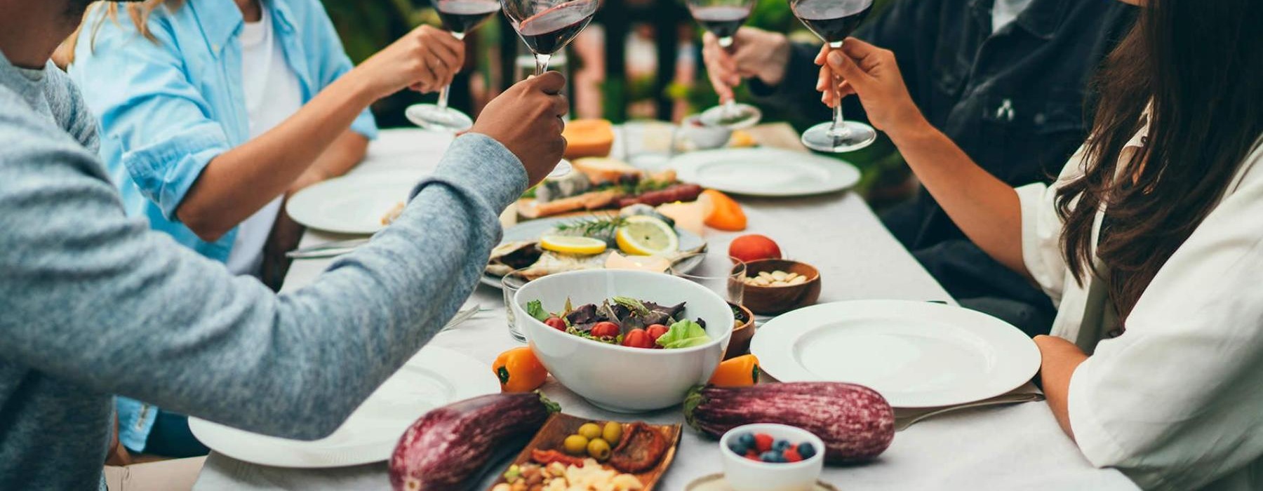 a group of people having a meal around an outdoor table