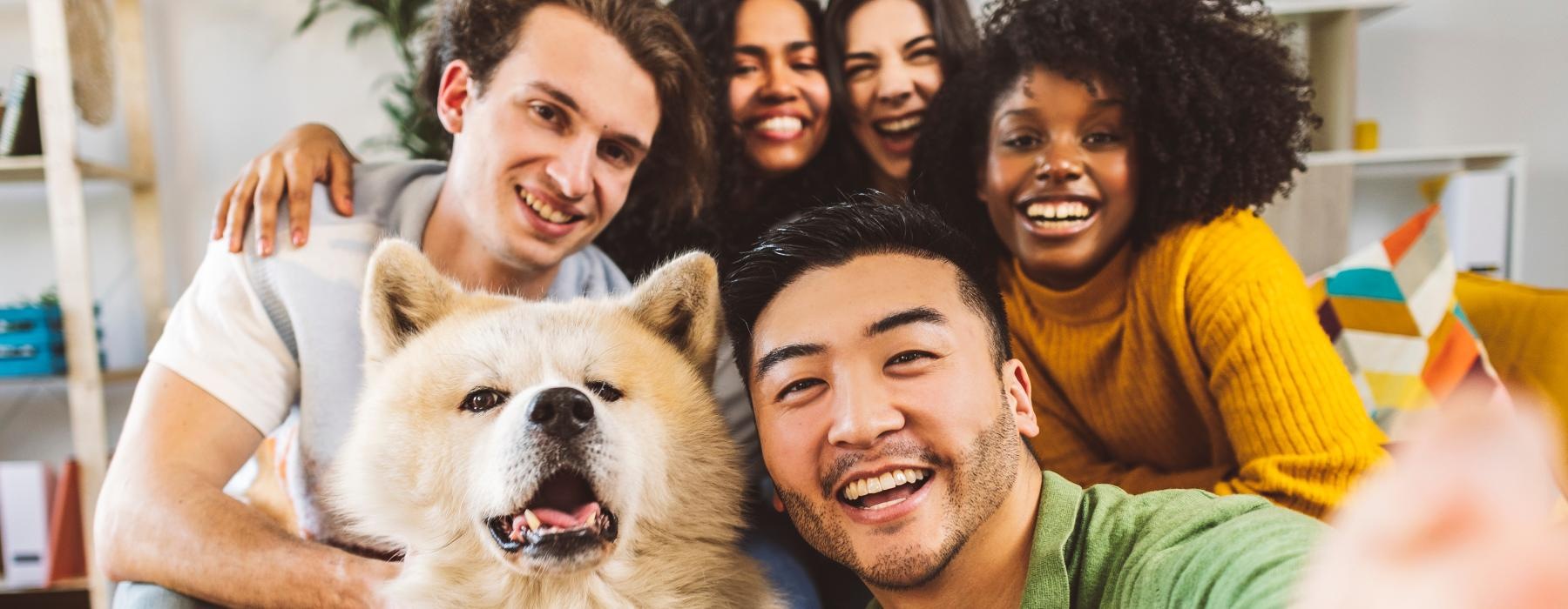 a group of people posing for a photo with a dog